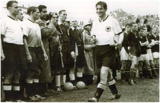 Fussballweltmeisterschaft in der Schweiz Finale Deutschland - Ungarn 3:2 (2:2) U.B.z. Kapitaen Fritz Walter (laechelnd GER) mit dem Jules-Rimet-Pokal und einem kleinen Kasten. V.l. sind Karl Mai und Max Morlock zu erkennen. 04.07.1954 in Bern (Wankdorf-Stadion) - Schweiz -Archiv