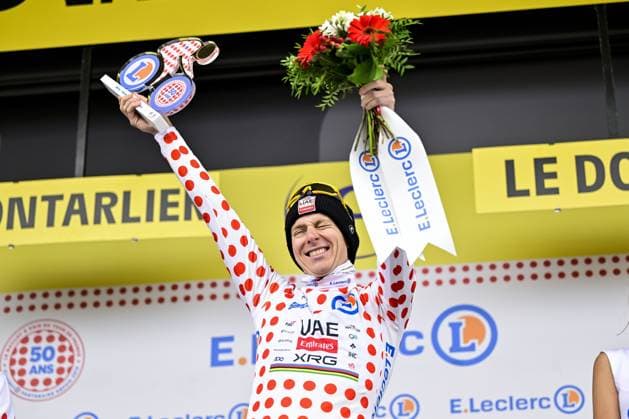 Slovenian Tadej Pogacar of UAE Team Emirates celebrates on the podium in the red polka-dot jersey for best climber after stage 20 of the 2025 Tour de France cycling race, from Nantua to Montpellier (185km), on Saturday 26 July 2025 in France. The 112th edition of the Tour de France starts on Saturday 5 July in Lille, France, and will finish in Paris, France on the 27th of July. DIRKxWAEM  x130056948x