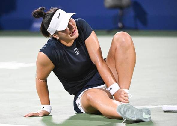 July 27, 2025, Montreal, Pq, Canada: Bianca Andreescu, of Canada, holds her ankle following a fall during her first round match against Barbora Krejcikova, of the Czech Republic, at the National Bank Open tennis tournament in Montreal, Sunday, July 27, 2025. Barbora Krejcikova, Bianca Andreescu, - ZUMAc35_ 20250727_zaf_c35_061 Copyright: xGrahamxHughesx