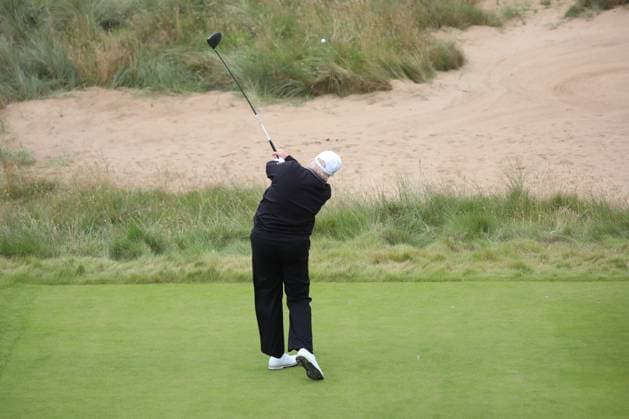 American President Donald Trump hits the first ball at The New Course at Trump International Links, Aberdeen in Scotland on Tuesday, July 29, 2025. Trump is on a four day visit to Scotland where he will be playing golf and meeting International leaders for trade discussions.  LON2025072904 HUGOxPHILPOTT