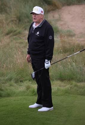 American President Donald Trump reacts after hitting the first ball at The New Course at Trump International Links, Aberdeen in Scotland on Tuesday, July 29, 2025. Trump is on a four day visit to Scotland where he will be playing golf and meeting International leaders for trade discussions.  LON2025072931 HUGOxPHILPOTT