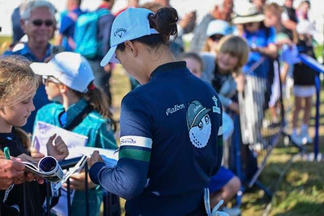 30th July 2025; Royal Porthcawl Golf Club, Porthcawl, Wales; AIG Womens Open Golf, Practice Day; Minjee Lee signing fans items in a malbon sweater  AledxHopkins