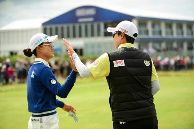 1st August 2025; Royal Porthcawl Golf Club, Porthcawl, Wales; AIG Womens Open Golf, Round 2; Minjee Lee high fives Hyo& x2011;Joo Kim as they pass on the course  AledxHopkins