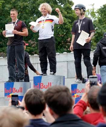 03.08.2025 BMX Deutsche Freestyle Meisterschaft 2025 in Park und Flatland im Bikepark Darmstadt hier Siegerehrung Freestyle Park Elite mit Julius KNAPP (2. Platz) Philipp MUTH mit zu kleiner Jacke (1. Platz) Dean FLORIAN (3. Platz) verleiht Goldmedaille Bundestrainer Mark König Darmstadt Hessen Deutschland