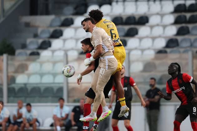 Vincenzo Polito (left) of Hamrun Spartans vies for the ball with Roi Mishpati, goalkeeper of Maccabi Tel Aviv and Tyrese Asante during the the UEFA Europa League Third qualifying round, 1st leg soccer match between Hamrun Spartans FC and Maccabi Tel Aviv FC at the Tony Bezzina Stadium, in Paola, Malta, on 05 August 2025. UEFA Europa League - Hamrun Spartans FC v Maccabi Tel Aviv FC