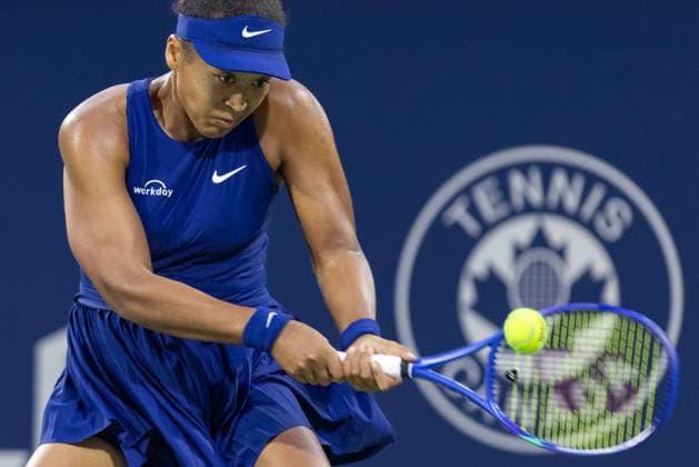 August 5, 2025, Montreal, Quebec, Canada: NAOMI OSAKA from Japan back hits a backhand in the first set against Svitolina (10) from Ukraine in the quarter final at Canadian Open at IGA stadium. Osaka won 6:2 6:2. Montreal Canada - ZUMAl189 20250805_zsp_l189_030 Copyright: xYannickxLegarex