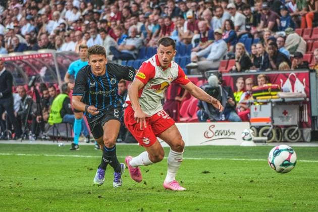 Fussball Österreich, UEFA Champions League 2025 2026, 3. Qualifikationsrunde - Red Bull Salzburg vs. Club Brügge - Red Bull Arena (Salzburg, Wals-Siezenheim, Österreich): Christos Tzolis (Club Brugge KV) mit Stefan Lainer (Reb Bull Salzburg) Copyright: xLukasxBierederx