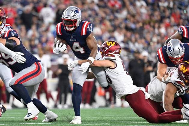 Aug 8, 2025; Foxborough, MA, USA; New England Patriots running back Antonio Gibson (4) is tackled by Washington Commanders linebacker Kain Medrano (56) as he runs the ball during the first half at Gillette Stadium. CSM Foxborough USA - ZUMAc04_ 20250808_faf_c04_017 Copyright: xEricxCanhax