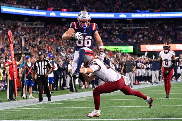 Aug 8, 2025; Foxborough, MA, USA; New England Patriots wide receiver Efton Chism III (86) leapfrogs over Washington Commanders safety Ben Nikkel (48) for a touchdown during the second half at Gillette Stadium. CSM Foxborough USA - ZUMAc04_ 20250808_faf_c04_024 Copyright: xEricxCanhax