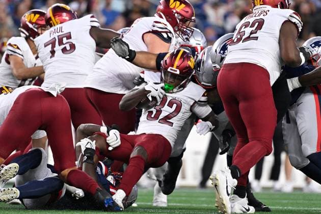 Aug 8, 2025; Foxborough, MA, USA; Washington Commanders running back Jacory Croskey-Merritt (32) is stopped by the New England Patriots during the first half at Gillette Stadium. CSM Foxborough USA - ZUMAc04_ 20250808_faf_c04_032 Copyright: xEricxCanhax