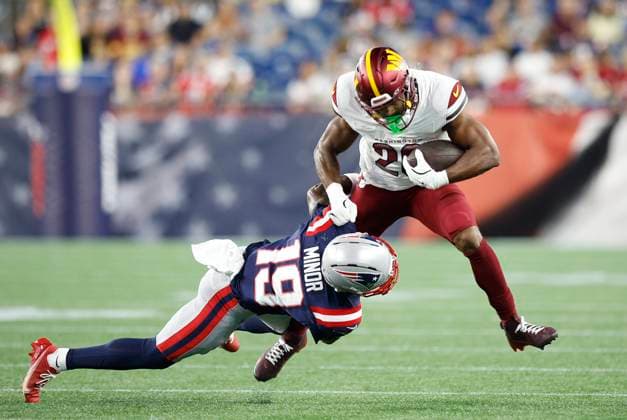 FOXBOROUGH, MA - AUGUST 08: Washington Commanders running back Jeremy McNichols (26) is tackled by New England Patriots cornerback Kobee Minor (19) during the NFL, American Football Herren, USA preseason game between Washington Commanders and New England Patriots on August 8, 2025, at Gillette Stadium in Foxborough, MA. (Photo by M. Anthony Nesmith Icon Sportswire) NFL: AUG 08 Preseason Commanders at Patriots EDITORIAL USE ONLY Icon25080824