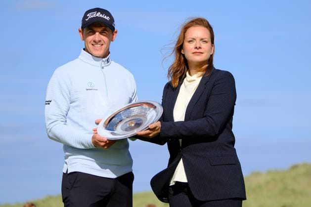 UK: Nexo Championship, Old Course at Trump International Golf Links, Aberdeen, Scotland on 10 August 2025: Pictured: Grant Forrest (Scotland) celebrates is presently with the Nexo Championship 2025 trophy by Nexo Head of Communications Eleonor Genova at Trump International Golf Links, Aberdeenshire, Scotland Aberdeen Trump International Golf Links Scotland Copyright: xAlexxToddx