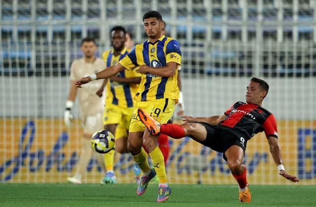 (250815) -- BACKA TOPOLA, Aug. 15, 2025 -- Elad Madmon (L) of Maccabi Tel-Aviv vies with Matias Garcia (R) of Hamrun Spartans during the third qualifying round 2nd leg football match between Maccabi Tel-Aviv of Israel and Hamrun Spartans of Malta at the UEFA Europa League in Backa Topola, Serbia, Aug. 14, 2025. (Photo by Xinhua) (SP)SERBIA-BACKA TOPOLA-FOOTBALL-UEFA EUROPA LEAGUE-MACCABI TEL AVIV VS HAMRUN SPARTANS PredragxMilosavljevic 