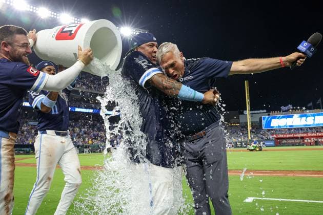 August 15, 2025: Kansas City Royals catcher Salvador Perez (13) hugs broadcaster Joel Goldberg as they are doused by center fielder Kyle Isbel (28) and third baseman Maikel Garcia (11) after their win over the Chicago White Sox at Kauffman Stadium in Kansas City, MO. CSM Kansas City United States of America - ZUMAc04_ 20250815_zma_c04_232 Copyright: xDavidxSmithx