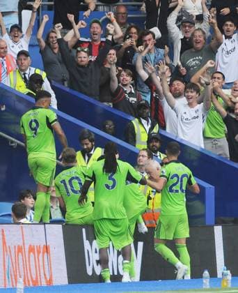 Football - 2025 2026 Premier League - Brighton & Hove Albion vs Fulham - Amex Stadium - Saturday 6th August 2025 Rodrigo Muniz of Fulham jumps onto the hordings after scoring the equalising goal in the last minute of injury time to celebrate with their fans 