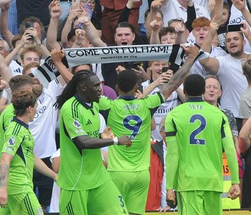 Football - 2025 2026 Premier League - Brighton & Hove Albion vs Fulham - Amex Stadium - Saturday 6th August 2025 Rodrigo Muniz of Fulham picks up a Fulham scarf after scoring the equalising goal in the last minute of injury time to celebrate with their fans 