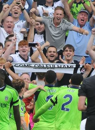 Football - 2025 2026 Premier League - Brighton & Hove Albion vs Fulham - Amex Stadium - Saturday 6th August 2025 Rodrigo Muniz of Fulham picks up a Fulham scarf after scoring the equalising goal in the last minute of injury time to celebrate with their fans 