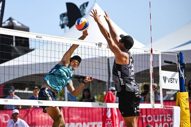 MONTREAL, QC - AUGUST 16: Izac Carracher (AUS) smashes the ball against Sven Winter (GER) during a round of 12 match at Beach Pro Tour Montreal Elite 16 on August 16, 2025 at Parc Jean-Drapeau in Montreal, QC (Photo by David Kirouac Icon Sportswire) VOLLEYBALL: AUG 16 Beach Pro Tour Montreal Elite 16 EDITORIAL USE ONLY Icon250816012