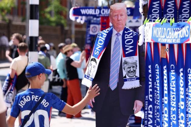 London, England, 17th August 2025. A Chelsea fan walks past a cardboard cut out, Freisteller of President Donald Trump wearing a World Champions scarf ahead of the Chelsea vs Crystal Palace Premier League match at Stamford Bridge, London. Picture credit should read: Paul Terry Sportimage EDITORIAL USE ONLY. No use with unauthorised audio, video, data, fixture lists, club league logos or live services. Online in-match use limited to 120 images, no video emulation. No use in betting, games or single club league player publications. SPI_004_PT_Chelsea_Crystal_Palace SPI-4073-0004