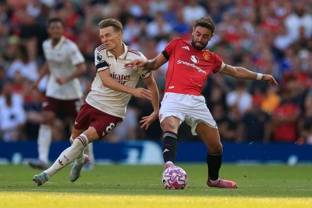 Manchester United, ManU v Arsenal Premier League 17 08 2025. Bruno Fernandes (8) of Manchester United and Martin Odegaard (8) of Arsenal challenge for the ball during the Premier League match between Manchester United and Arsenal at Old Trafford, Manchester, England on 17 August 2025. Manchester Old Trafford Greater Manchester England Editorial use only DataCo restrictions apply See www.football-dataco.com , Copyright: xConorxMolloyx PSI-22618-0053