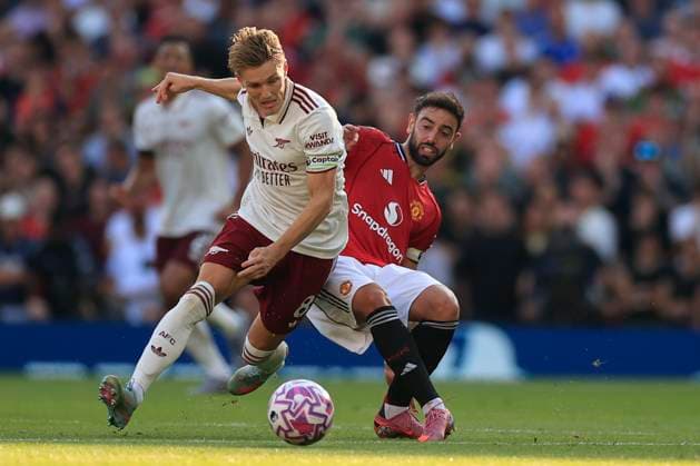 Manchester United, ManU v Arsenal Premier League 17 08 2025. Martin Odegaard (8) of Arsenal and Bruno Fernandes (8) of Manchester United challenge for the ball during the Premier League match between Manchester United and Arsenal at Old Trafford, Manchester, England on 17 August 2025. Manchester Old Trafford Greater Manchester England Editorial use only DataCo restrictions apply See www.football-dataco.com , Copyright: xConorxMolloyx PSI-22618-0093