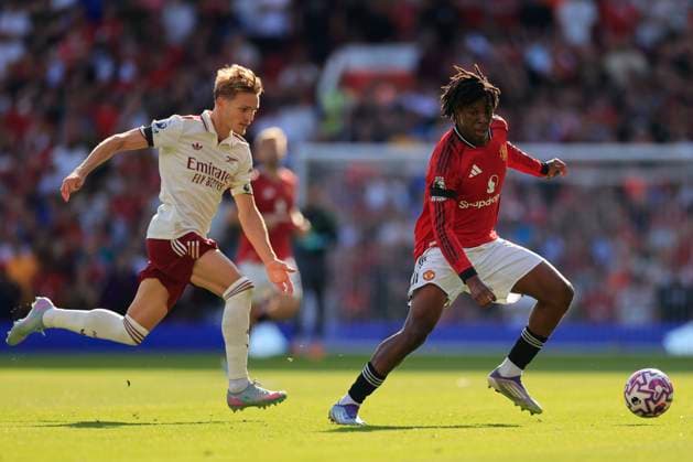 Manchester United, ManU v Arsenal Premier League 17 08 2025. Martin Odegaard (8) of Arsenal closes in on Patrick Dorgu (13) of Manchester United during the Premier League match between Manchester United and Arsenal at Old Trafford, Manchester, England on 17 August 2025. Manchester Old Trafford Greater Manchester England Editorial use only DataCo restrictions apply See www.football-dataco.com , Copyright: xConorxMolloyx PSI-22618-0126