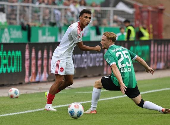 22.08.2025 - Fussball - Saison 2025 2026 - 2. Fussball - Bundesliga - 03. Spieltag: SC Preußen Münster SCP - 1. FC Nürnberg FCN ( Club ) - Sportfoto Zink DaMa - xdaxmax - DFL regulations prohibit any use of photographs as image sequences and or quasi-video - only for editorial use - Henri Koudossou (8, 1. FC Nürnberg FCN ) Luca Bolay (25, Preußen Münster )