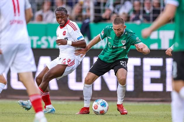 22.08.2025, Fußball, Preußen Münster - 1. FC Nürnberg, 2. Fußball Bundesliga, Preußenstadion, Saison 2025 2026: Mohamed AlÃ¬ Zoma (1FC Nuernberg 23) im Zweikampf gegen Rico Preißinger (Preussen Muenster 21) DFB regulations prohibit any use of photographs as image sequences and or quasi-video. Nordrhein-Westfalen Deutschland