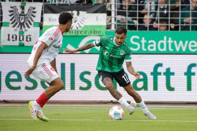 22.08.2025, xgrfx, Fussball 2.Bundesliga, Preußen Münster - 1.FC Nürnberg v.l. Semir Telalovic (1.FC Nürnberg), Oliver Batista Meier (Preußen Münster) (DFL DFB REGULATIONS PROHIBIT ANY USE OF PHOTOGRAPHS as IMAGE SEQUENCES and or QUASI-VIDEO) Münster