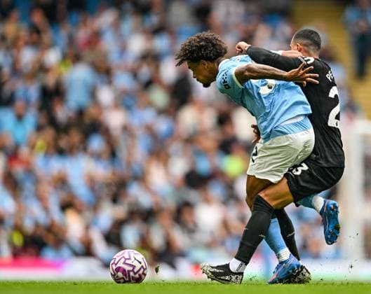 23rd August 2025; Etihad Stadium, Manchester, England; Premier League Football, Manchester City versus Tottenham Hotspur; Oscar Bobb of Manchester City holds off Pedro Porro of Tottenham Hotspur  GodfreyxPitt