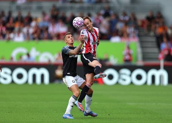 23rd August 2025; Gtech Community Stadium, Brentford, London, England; Premier League Football, Brentford versus Aston Villa; Mikkel Damsgaard of Brentford heads the ball above Lucas Digne of Aston Villa  JohnxPatrickxFletcher