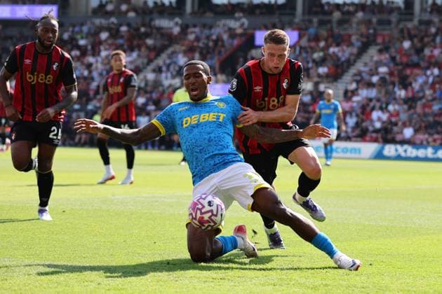 Football - 2025 2026 Premier League - AFC Bournemouth vs Wolverhampton Wanderers - The Vitality Stadium - Saturday 23rd August 2025 Adrien Truffert of Bournemouth holds off Jackson Tchatchoua of Wolverhampton during the Premier League match at the Vitality Stadium COLORSPORT Shaun Boggust 