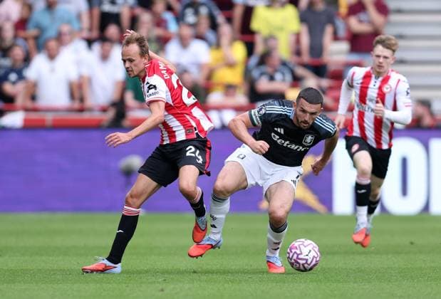 London, England, 23rd August 2025. Mikkel Damsgaard of Brentford and John McGinn of Aston Villa challenge for the ball during the Brentford vs Aston Villa Premier League match at Gtech Community Stadium, London. Picture credit should read: Paul Terry Sportimage EDITORIAL USE ONLY. No use with unauthorised audio, video, data, fixture lists, club league logos or live services. Online in-match use limited to 120 images, no video emulation. No use in betting, games or single club league player publications. SPI_020_PT_Brentford_Aston_Villa SPI-4082-0020