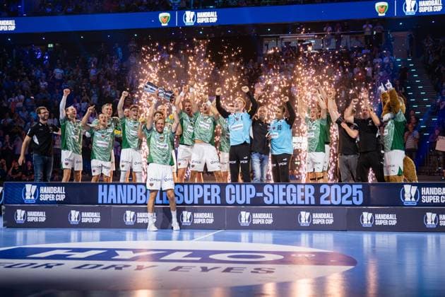 Fuechse Berlin gegen THW Kiel, Handball, 1. Handball Bundesliga Herren, Supercup, Saison 2025 2026, Muenchen, 23.08.2025 Die Mannschaft der Fuechse Berlin jubelt nach dem Sieg des Supercups. Max Darj (Fuechse Berlin, 05) hebt den Pokal Muenchen SAP Garden Deutschland