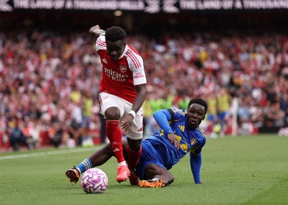 London, England, 23rd August 2025. Bukayo Saka of Arsenal with Wilfried Gnonto of Leeds United during the Arsenal vs Leeds United Premier League match at the Emirates Stadium, London. Picture credit should read: David Klein Sportimage EDITORIAL USE ONLY. No use with unauthorised audio, video, data, fixture lists, club league logos or live services. Online in-match use limited to 120 images, no video emulation. No use in betting, games or single club league player publications. SPI_063_DK_Arsenal_Leeds SPI-4090-0063