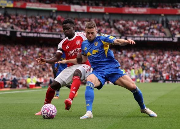 London, England, 23rd August 2025. Bukayo Saka of Arsenal with Gabriel Gudmundsson of Leeds United during the Arsenal vs Leeds United Premier League match at the Emirates Stadium, London. Picture credit should read: David Klein Sportimage EDITORIAL USE ONLY. No use with unauthorised audio, video, data, fixture lists, club league logos or live services. Online in-match use limited to 120 images, no video emulation. No use in betting, games or single club league player publications. SPI_065_DK_Arsenal_Leeds SPI-4090-0065