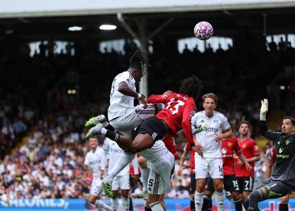 24th August 2025; Craven Cottage, Fulham, London, England; Premier League Football, Fulham versus Manchester United, ManU Calvin Bassey of Fulham heads the ball above Patrick Dorgu of Manchester United  JohnxPatrickxFletcher