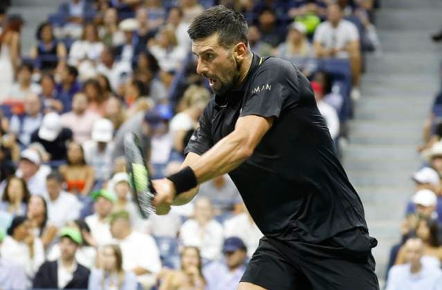 Novak Djokovic of Serbia hits a backhand against Learner Tien in a Men s Singles first round match at the 2025 US Open Tennis Championship at the USTA Billie Jean King National Tennis Center in New York City on Sunday, August 24, 2025.  NYP20250824832 JOHNxANGELILLO