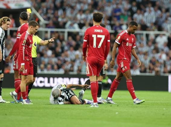 Newcastle Upon Tyne, England, 25th August 2025. Yellow card for Ryan Gravenberch (R) of Liverpool during the Newcastle United vs Liverpool Premier League match at St. James Park, Newcastle Upon Tyne. Picture credit should read: Nigel Roddis Sportimage EDITORIAL USE ONLY. No use with unauthorised audio, video, data, fixture lists, club league logos or live services. Online in-match use limited to 120 images, no video emulation. No use in betting, games or single club league player publications. SPI_023_NR_NEWC_LIVE SPI-4089-0023