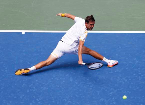 Vit Kopriva of Czechia stretches out to return a ball to Jannik Sinner of Italy in the first set of their first round match in Arthur Ashe Stadium on day 3 at the 2025 US Open Tennis Championship at the USTA Billie Jean King National Tennis Center in New York City on Tuesday, August 26, 2025.  NYP20250826127 JOHNxANGELILLO