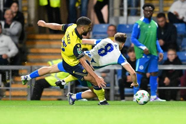 Oxford United v Brighton and Hove Albion EFL Cup 27 08 2025. Oxford United defender Brodie Spencer (15) fouls Brighton and Hove Albion midfielder Brajan Gruda during the EFL Cup match between Oxford United and Brighton and Hove Albion at the Kassam Stadium, Oxford, England on 27 August 2025. Oxford Kassam Stadium Oxfordshire England Editorial use only DataCo restrictions apply See www.football-dataco.com , Copyright: xDennisxGoodwinx PSI-22704-0021