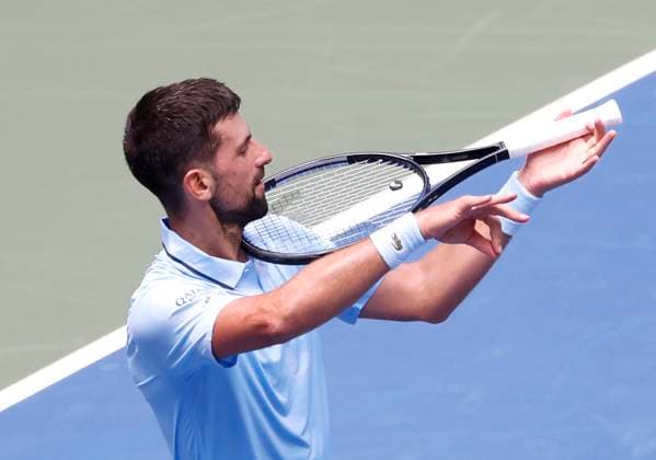 Novak Djokovic of Serbia celebrates by playing the violin on his tennis racket after defeating Zachary Svajda in 4 sets in his second round match in Arthur Ashe Stadium on day 4 at the 2025 US Open Tennis Championship at the USTA Billie Jean King National Tennis Center in New York City on Wednesday, August 27, 2025.  NYP20250827101 JOHNxANGELILLO