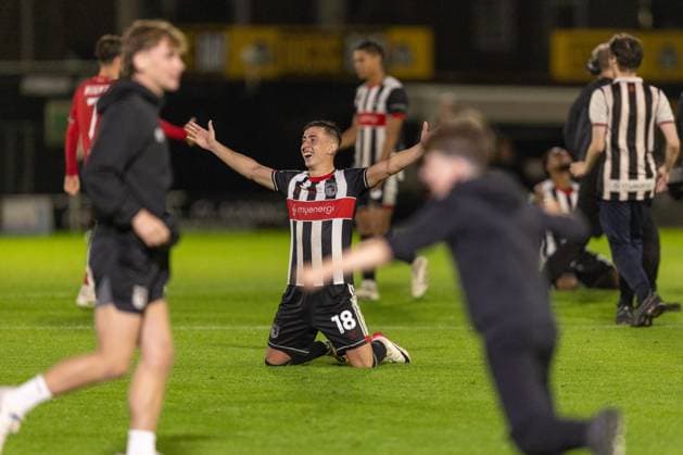 Grimsby Town FC v Manchester United, ManU EFL Cup 27 08 2025. Darragh Burns of Grimsby Town celebrates after winning the match on penalties as the fans rush on to the pitch during the EFL Cup match between Grimsby Town FC and Manchester United at Blundell Park, Grimsby, United Kingdom on 27 August 2025. Editorial use only DataCo restrictions apply See www.football-dataco.com , Copyright: xJezxTighex PSI-22699-0105
