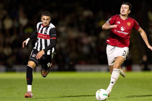 Grimsby Town FC v Manchester United, ManU EFL Cup 27 08 2025. Jaze Kabia of Grimsby Town and Harry Maguire of Manchester United during the EFL Cup match between Grimsby Town FC and Manchester United at Blundell Park, Grimsby, United Kingdom on 27 August 2025. Editorial use only DataCo restrictions apply See www.football-dataco.com , Copyright: xJezxTighex PSI-22699-0118