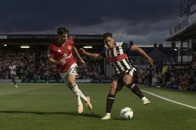 Grimsby Town FC v Manchester United, ManU EFL Cup 27 08 2025. Evan Khouri of Grimsby Town and Tyler Fredricson of Manchester United during the EFL Cup match between Grimsby Town FC and Manchester United at Blundell Park, Grimsby, United Kingdom on 27 August 2025. Editorial use only DataCo restrictions apply See www.football-dataco.com , Copyright: xJezxTighex PSI-22699-0211