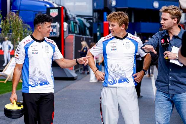 Isack Hadjar of France and Racing Bulls and Liam Lawson of New Zealand and Racing Bulls and Viaplay presenter Chiel van Koldenhoven of the Netherlands prior to the start of the Formula 1 Heineken Dutch Grand Prix 2025 at Circuit Zandvoort on August 28, 2025 in Zandvoort, Netherlands. (Photo by Marcel ter Bals DeFodi Images)
