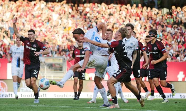 29.08.2025, xmohx, Fussball 2.Bundesliga, 1. FC Nuernberg - SC Paderborn 07 v.l. Tim Janisch (Nürnberg) foult Luis Engelns (Paderborn), darufhin zeigt Schiedsrichter Michael Bacher ihm die rote Karte, Janisch zeigt anschließend enttäuscht und die rote Karte wird durch den VAR zurückgenommen. (DFL DFB REGULATIONS PROHIBIT ANY USE OF PHOTOGRAPHS as IMAGE SEQUENCES and or QUASI-VIDEO) Nuernberg