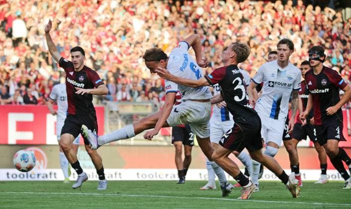 29.08.2025, xmohx, Fussball 2.Bundesliga, 1. FC Nuernberg - SC Paderborn 07 v.l. Tim Janisch (Nürnberg) foult Luis Engelns (Paderborn), darufhin zeigt Schiedsrichter Michael Bacher ihm die rote Karte, Janisch zeigt anschließend enttäuscht und die rote Karte wird durch den VAR zurückgenommen. (DFL DFB REGULATIONS PROHIBIT ANY USE OF PHOTOGRAPHS as IMAGE SEQUENCES and or QUASI-VIDEO) Nuernberg