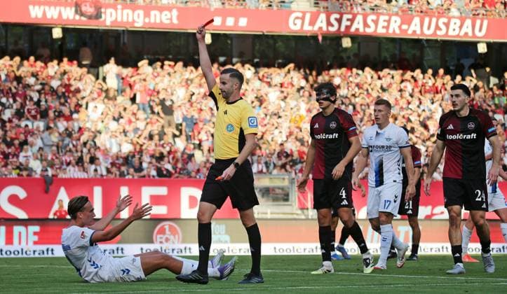 29.08.2025, xmohx, Fussball 2.Bundesliga, 1. FC Nuernberg - SC Paderborn 07 v.l. Tim Janisch (Nürnberg) foult Luis Engelns (Paderborn), darufhin zeigt Schiedsrichter Michael Bacher ihm die rote Karte, Janisch zeigt anschließend enttäuscht und die rote Karte wird durch den VAR zurückgenommen. (DFL DFB REGULATIONS PROHIBIT ANY USE OF PHOTOGRAPHS as IMAGE SEQUENCES and or QUASI-VIDEO) Nuernberg