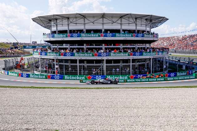 Oliver Bearman of the United Kingdom and Haas F1 Team and Lando Norris of the United Kingdom and McLaren F1 Team come out of the pit during the Free Practice of the Formula 1 Heineken Dutch Grand Prix 2025 on Day 2 at Circuit Zandvoort on August 30, 2025 in Zandvoort, Netherlands. (Photo by Marcel ter Bals DeFodi Images)